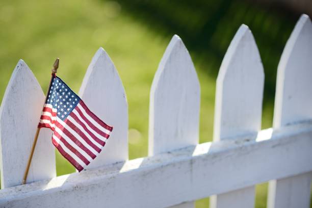 American Flag on white picket fence for Memorial Day or Labor Day.