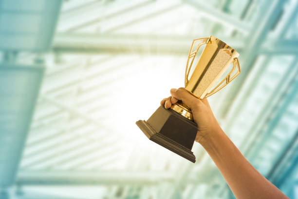 istock Business people holding trophy award 836555448