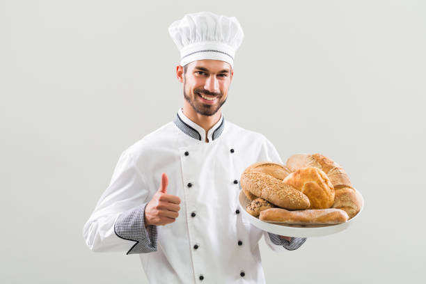 istock Baker holding bunch of bread and showing thumb up 836555646