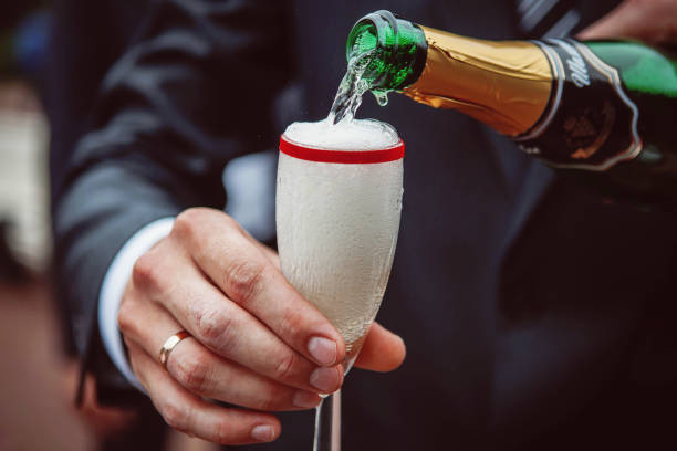 istock Champagne is poured into the glass 836555900
