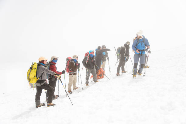 istock A team of climbers led by a guide discusses the upcoming ascent 836556052