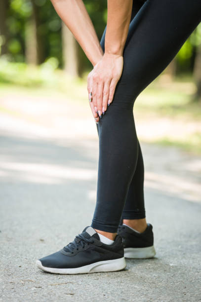 istock woman knee pain in a park 836556096