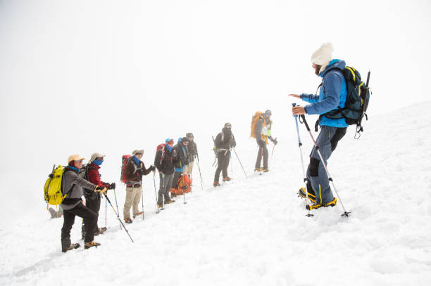 istock A team of climbers led by a guide discusses the upcoming ascent 836556102