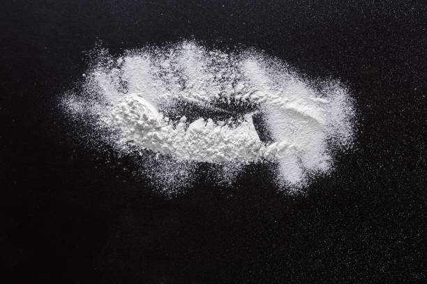 istock Sprinkled wheat flour splash spots on black background 836558842