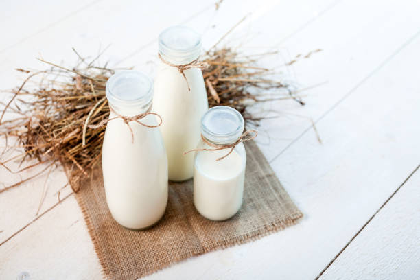 istock bottles of milk on a wooden rustic table. 836558932