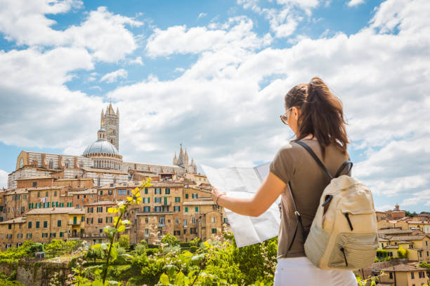 Young woman tourist with map in Siena.