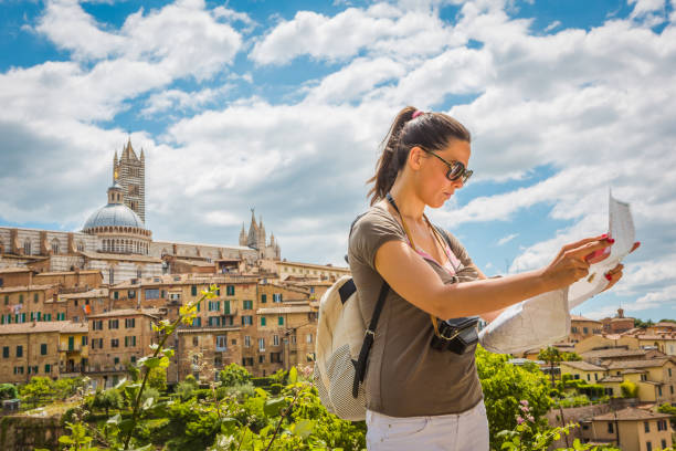 istock Young woman tourist with map in Siena. 836559084