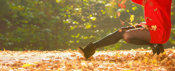 istock Playful woman outdoors playing with leaves. 836563614