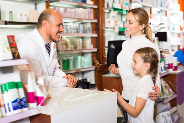 istock Laughing male pharmacist helping customers 836564036