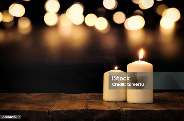 Burning Candles Over Old Wooden Table With Bokeh Lights Stock Photo - Download Image Now