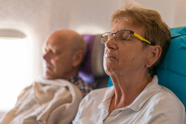 istock Airport, senior couple sleeping in airplane 836566930