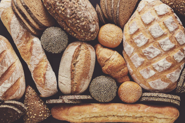 istock Bread background, top view of white, black and rye loaves 836569442