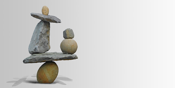 Land art in balancing stones on a gray background.