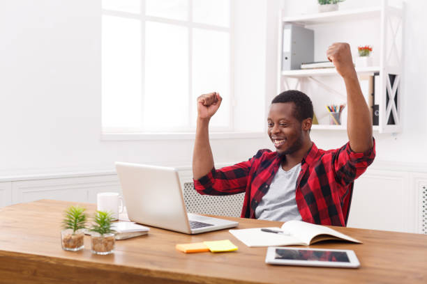 istock Happy businessman win. Winner, black man in office 836574334
