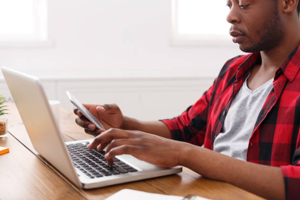 istock Black businessman in casual office, work with laptop 836574798