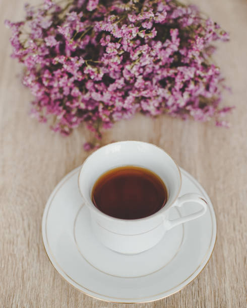 istock Black coffee with Dry flowers on wood table. 836575556