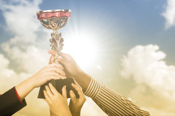 istock Businessman team holding award trophy 836578556