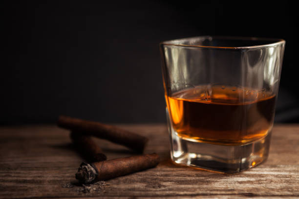 istock Cigar and glass with brandy on the table 836582906