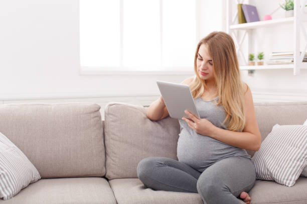 istock Happy pregnant woman using digital tablet. 836583072