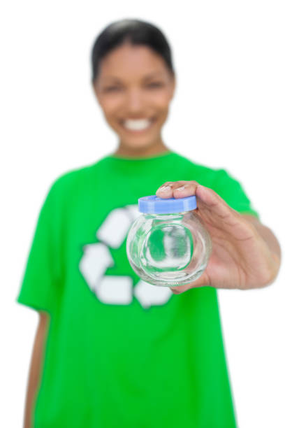 Cheerful model wearing recycling tshirt holding pot on white background