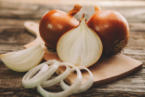 istock Onion bulb on chopping board with onion slices 836587376