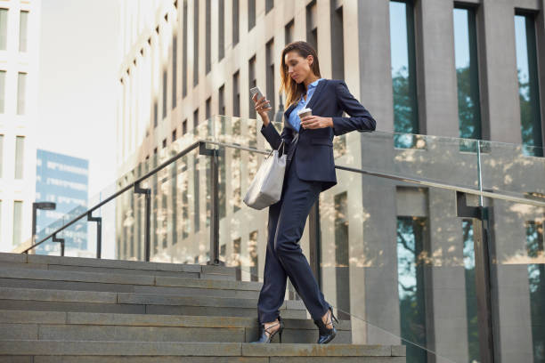 istock Businesswoman using mobile phone on steps in city 836587672