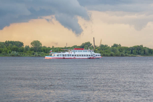 Pleasure boat on the background of a beautifully lighted cloud in the evening
