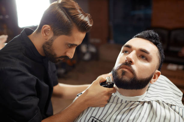 istock Stylish barber shaving man 836593938