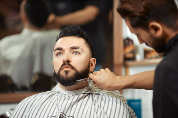 istock Barber grooming man in chair 836594052