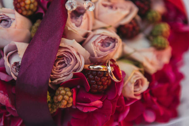 istock wedding rings on colorful flowers 836594952