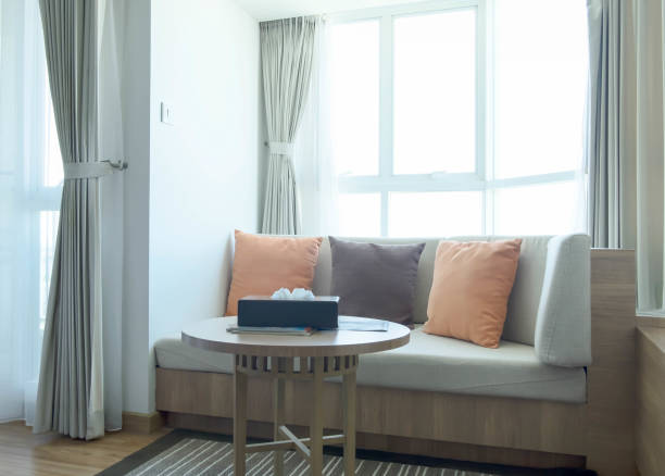 istock Corner sofa set with three pillows in modern style, Sunny day outside windows, Luxury tone color of curtain, Rest area for people to lie down and sleep or recess 836597466