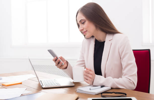istock Young business woman working on phone 836600724