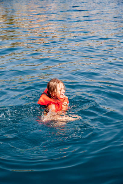 istock Girl Swimming in the Sea using Life Jacket 836602394