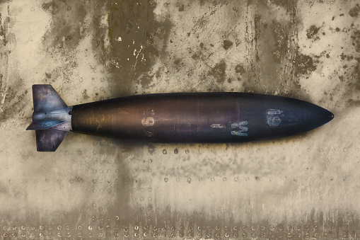 Ancient military missile bomb in front of an eroded steel background