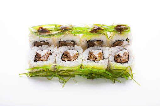 Healthy japanese restaurant food delivery. Set of colorful rolls with soy, philadelphia soft cheese and seaweed isolated at white background, closeup