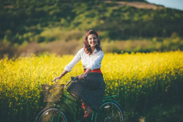 Photo of Young girl riding her green retro hipster bike