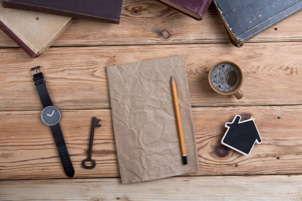 istock Top view on wooden desktop with books, watch and copy space for text 836610370