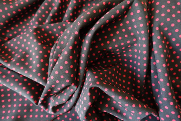 istock Folded fabric with polka dot print in black and red 836611930