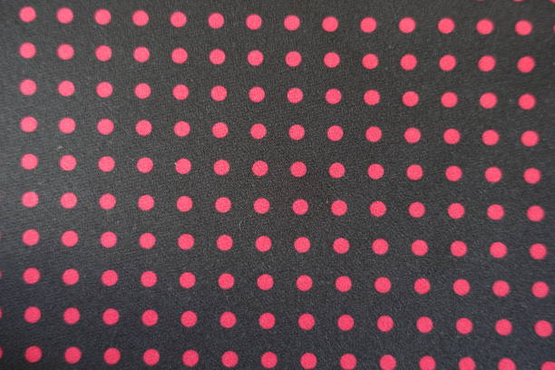 Plain black fabric with red polka dot print from above