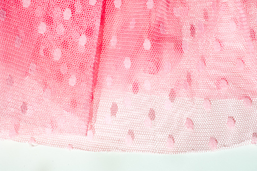 The texture of fabric lace with sequins on fabric background. Magenta, Hot pink, Cerise
