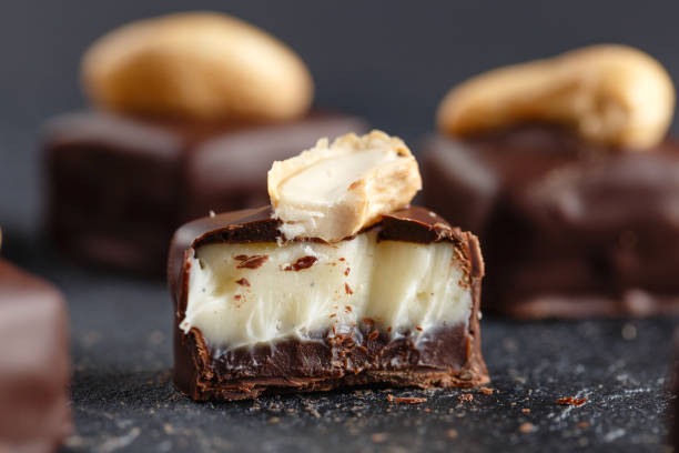 Cut chocolate candy with vanilla and chocolate ganache stock photo