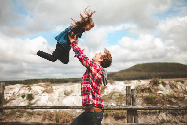 istock Brother playing with little sister in the meadow 836627150