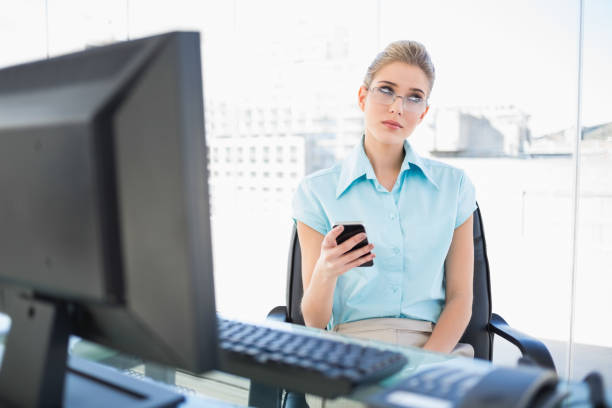 istock Pensive businesswoman wearing glasses text messaging 836630666