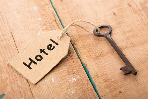 istock hotel key with tag on the wooden background 836633998