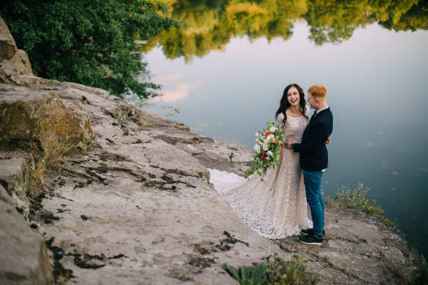 istock Happy newlyweds standing on the river bank 836638486
