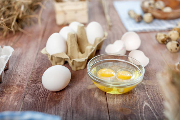 istock Close-up view of raw chicken eggs on wooden background 836638536