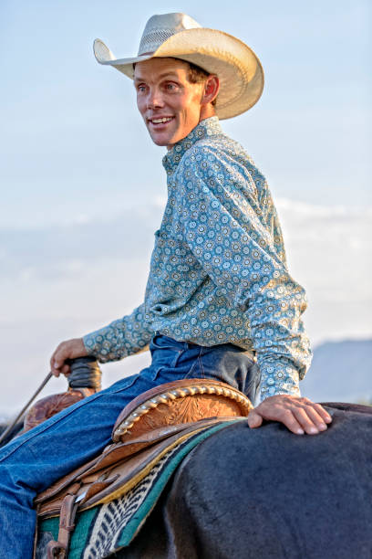 istock A Cowboy Turns Around While Sitting in the Saddle on His Horse 836638564