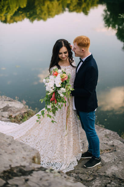 istock Happy newlyweds standing on the river bank 836640746