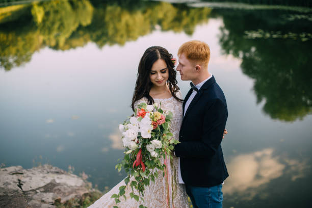 istock Happy newlyweds standing on the river bank 836640922