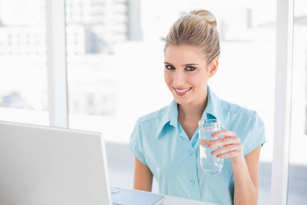 istock Smiling well dressed businesswoman holding water 836641076
